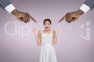 Hands pointing at surprised business woman against pink background