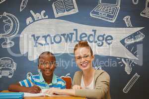 Happy student boy and teacher at table against blue blackboard with knowledge text and education and