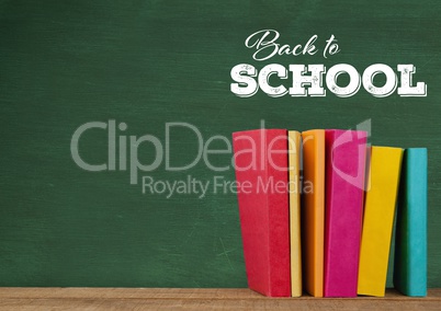 Back to school text on blackboard and Desk with books