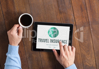 Man using a tablet with travel insurance concept on screen