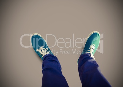 Green shoes on feet with brown background