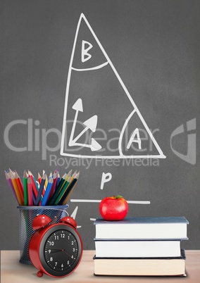 Books on the table against grey blackboard with education and school graphics