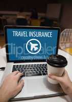 Person using a computer with travel insurance concept on screen