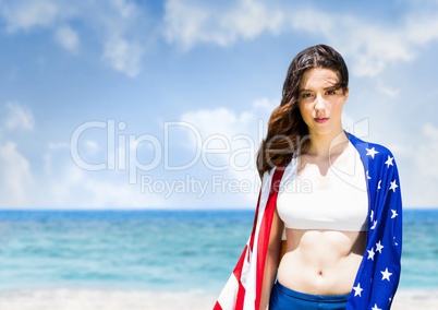 Woman holding a USA flag in the beach