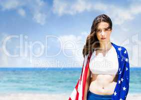 Woman holding a USA flag in the beach