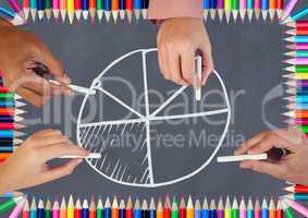 Hands drawing pie chart on blackboard with coloring pencils