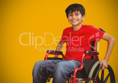Disabled boy in wheelchair with bright yellow background