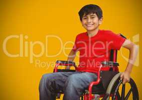 Disabled boy in wheelchair with bright yellow background