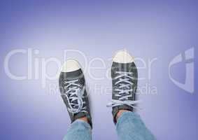 Grey shoes on feet with purple background