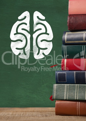 Books on Desk foreground with blackboard graphics of brain