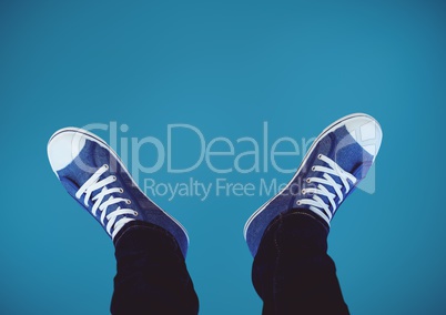 Blue shoes on feet with blue background