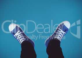 Blue shoes on feet with blue background