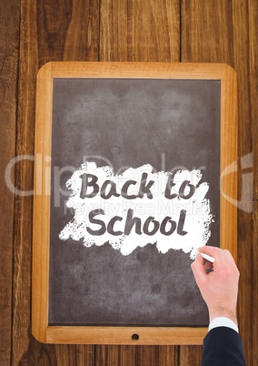 Hand writing back to school text on blackboard