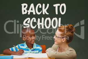 Student boy and teacher at table against green blackboard with back to school text