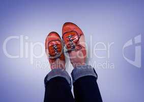 Red shoes on feet with purple background
