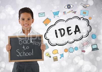 Boy holding back to school blackboard with idea graphics