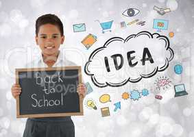 Boy holding back to school blackboard with idea graphics