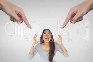 Hands pointing at angry woman against white background