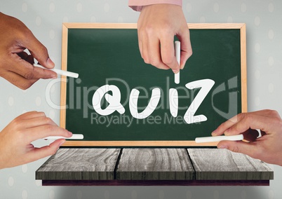 Hands writing quiz on blackboard
