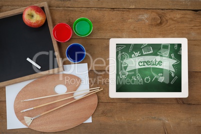 Tablet on a school table with school icons on screen