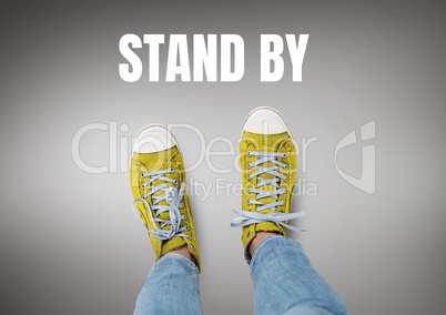 Stand by text and Yellow shoes on feet with grey background