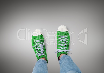 Green shoes on feet with grey background