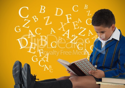 Many letters around Boy reading in front of yellow background