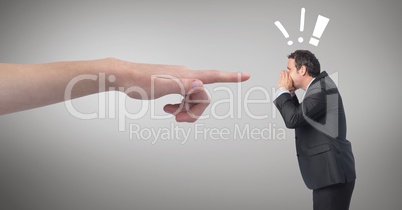Hand pointing at angry business man against grey background with exclamation icons