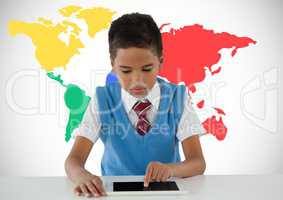 Schoolboy on tablet with colorful world map