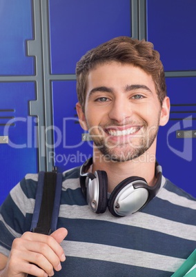 male student with headphones in front of lockers