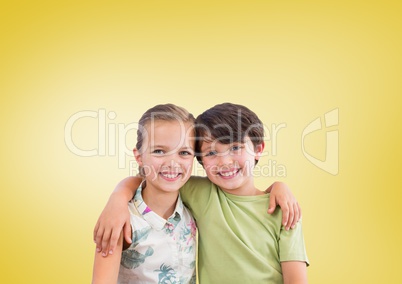 Boy and girl hugging in front of yellow background