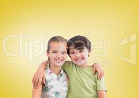 Boy and girl hugging in front of yellow background