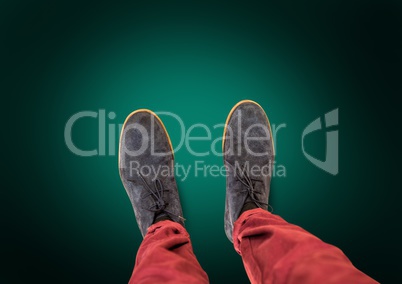 Grey shoes on feet with green background