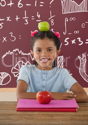 Student girl at table against red blackboard with education and school graphics