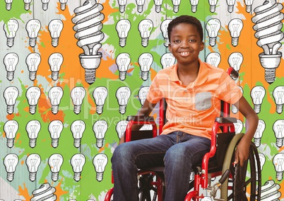 Disabled boy in wheelchair with light bulbs and paint drawings