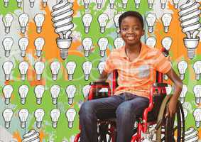 Disabled boy in wheelchair with light bulbs and paint drawings