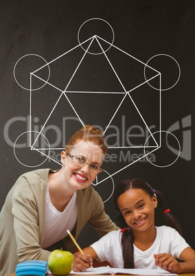 Happy student girl and teacher at table against grey blackboard with school and education graphic