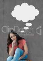 Young woman with speech bubble sitting against grey background