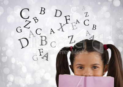Many letters around Girl reading in front of bright bokeh background