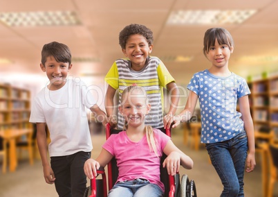 Disabled girl in wheelchair with friends in school library