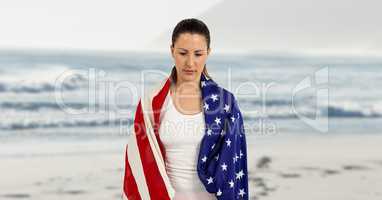 Woman holding a USA flag in the beach