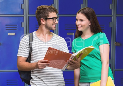 students holding book in front of lockers