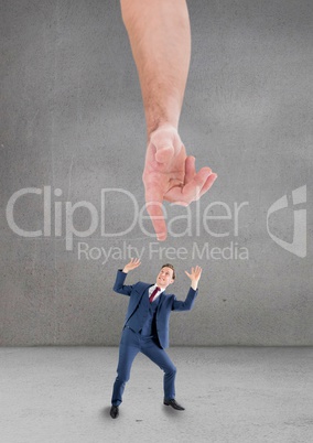 Hand pointing at scared business man against grey background