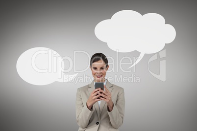 Business woman with speech bubble using a phone against grey background
