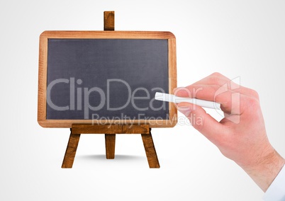 Hand writing with chalk on empty blackboard