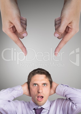 Hands pointing at surprised business man against grey background