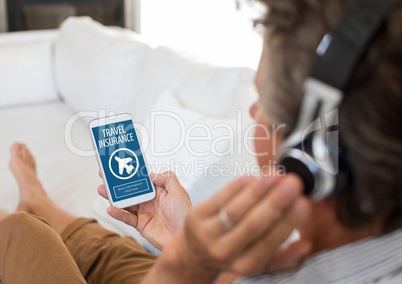 Man using a phone with travel insurance concept on screen