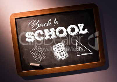 Back to school text on blackboard with chalk and stationery