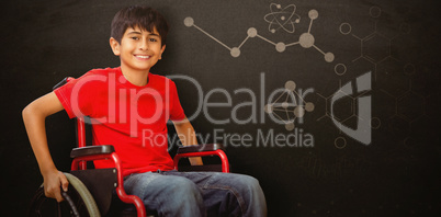 Composite image of portrait of boy sitting in wheelchair