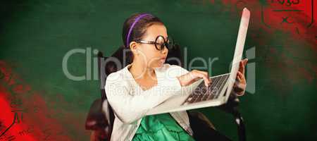 Composite image of young girl typing on laptop while sitting